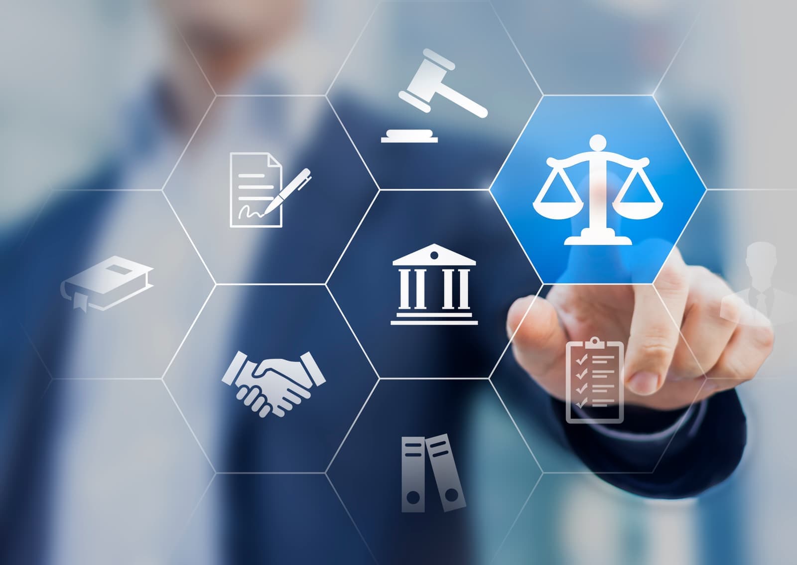 Hand selecting compliance icons: scales, contracts and checklists
